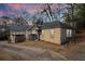 Side-rear view of a quaint home with a stone foundation and an adjacent driveway at 1815 Monroe Ne Dr, Atlanta, GA 30324