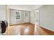 Room featuring a window, wood floors, painted grey walls, white door, and a heater at 1815 Monroe Ne Dr, Atlanta, GA 30324