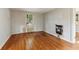 Room featuring a window, wood floors, painted grey walls, and a window AC unit at 1815 Monroe Ne Dr, Atlanta, GA 30324