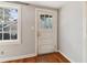Room featuring a window, wood floors, painted grey walls, and a white glass panel door at 1815 Monroe Ne Dr, Atlanta, GA 30324