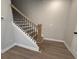 Staircase featuring wood treads, black metal spindles, and a white stringer at 1923 Cassia Aly, Kennesaw, GA 30144