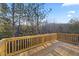 The back deck features a wooden railing overlooking the verdant trees in the back yard at 3175 Tackett Rd, Douglasville, GA 30135
