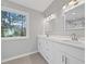 Bathroom with double vanity, marble countertops, and large window at 3175 Tackett Rd, Douglasville, GA 30135