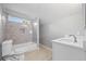 The bathroom has a shower over the tub, a white sink, and grey-tiled walls at 3175 Tackett Rd, Douglasville, GA 30135