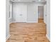 This bedroom features hardwood flooring, white trim, and a doorway into the hall at 3175 Tackett Rd, Douglasville, GA 30135