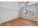 This bedroom features hardwood floors, large windows, and a ceiling fan at 3175 Tackett Rd, Douglasville, GA 30135