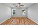 A spacious bedroom with hardwood floors and two large windows at 3175 Tackett Rd, Douglasville, GA 30135