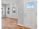 Entryway with hardwood floors and white front door with glass at 3175 Tackett Rd, Douglasville, GA 30135
