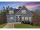 Charming two-story home with light blue siding, garage, and inviting front yard at 3175 Tackett Rd, Douglasville, GA 30135