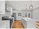 A modern kitchen with white cabinets, stainless steel appliances, and a large island at 3175 Tackett Rd, Douglasville, GA 30135