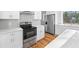 Kitchen featuring white cabinets, stainless steel appliances, and white countertops at 3175 Tackett Rd, Douglasville, GA 30135