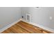 The laundry room features gleaming hardwood floors and grey walls with white trim at 3175 Tackett Rd, Douglasville, GA 30135