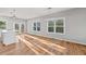 Open-concept living and dining area with hardwood floors and modern lighting fixtures at 3175 Tackett Rd, Douglasville, GA 30135