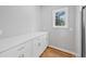 Well-lit room with white cabinets, marble countertops, and hardwood floors at 3175 Tackett Rd, Douglasville, GA 30135