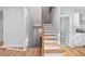 Wooden staircase with black metal railings and white risers leading to upper level at 3175 Tackett Rd, Douglasville, GA 30135