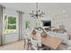 Dining room transitions into the living room, featuring modern chandelier, wood floors, and natural light at 628 Topsail Drive Pkwy, Villa Rica, GA 30180