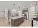 Bright open kitchen features stainless steel appliances, gray countertops, and a large central island with pendant lighting at 628 Topsail Drive Pkwy, Villa Rica, GA 30180