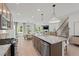 Spacious kitchen flows into the living room and dining area, highlighted by a large island and stainless steel appliances at 628 Topsail Drive Pkwy, Villa Rica, GA 30180