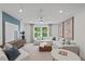 Spacious living room with a large sofa, lots of natural light, and stylish decorations at 628 Topsail Drive Pkwy, Villa Rica, GA 30180