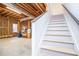 Unfinished basement with exposed beams and stairs leading to the main level at 2003 Hubbard Ct, Villa Rica, GA 30180