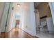 Hallway leading to a bathroom with a toilet, shower with curtain, and vanity with a mirror at 2003 Hubbard Ct, Villa Rica, GA 30180