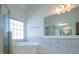 Bright bathroom featuring a soaking tub under a large window and a separate shower at 2003 Hubbard Ct, Villa Rica, GA 30180