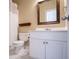 Cozy bathroom with a toilet, vanity with sink, framed mirror, and a shower with curtain at 2003 Hubbard Ct, Villa Rica, GA 30180