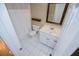 Well-lit bathroom featuring a toilet, vanity with a sink, and a shower with a curtain at 2003 Hubbard Ct, Villa Rica, GA 30180