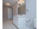 Bathroom with a single sink vanity, framed mirror, and neutral flooring at 2003 Hubbard Ct, Villa Rica, GA 30180