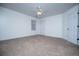 This bedroom features neutral carpeting, a ceiling fan, and a large window at 2003 Hubbard Ct, Villa Rica, GA 30180