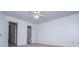 This bedroom features neutral carpeting, a ceiling fan, and multiple doors at 2003 Hubbard Ct, Villa Rica, GA 30180