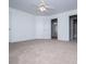 This bedroom features neutral carpeting, a ceiling fan, and multiple doors at 2003 Hubbard Ct, Villa Rica, GA 30180