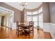 Dining room with natural light from bay windows, wainscoting, and hardwood floors at 2003 Hubbard Ct, Villa Rica, GA 30180