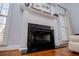 Elegant fireplace with a white mantel, black marble surround, and large windows at 2003 Hubbard Ct, Villa Rica, GA 30180