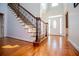 Elegant foyer with hardwood flooring, staircase with ornate railing, and abundant natural light at 2003 Hubbard Ct, Villa Rica, GA 30180