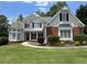 Charming two-story home features a well-manicured lawn and inviting curb appeal with black shutters at 2003 Hubbard Ct, Villa Rica, GA 30180
