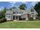 Charming two-story home features a well-manicured lawn and inviting curb appeal with black shutters at 2003 Hubbard Ct, Villa Rica, GA 30180
