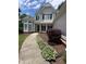 Charming two-story home with manicured landscaping along the curved walkway to the front entrance at 2003 Hubbard Ct, Villa Rica, GA 30180
