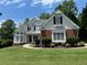Charming two-story home features a well-manicured lawn and inviting curb appeal with black shutters at 2003 Hubbard Ct, Villa Rica, GA 30180
