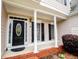 Inviting front porch with classic columns and decorative front door at 2003 Hubbard Ct, Villa Rica, GA 30180