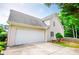 Spacious two-car garage featuring a large door and ample parking on the driveway at 2003 Hubbard Ct, Villa Rica, GA 30180
