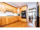 Well-lit kitchen featuring wooden cabinetry, white countertops and hardwood flooring at 2003 Hubbard Ct, Villa Rica, GA 30180