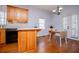 Bright kitchen with wooden cabinets, chandelier, and adjacent dining area with natural light at 2003 Hubbard Ct, Villa Rica, GA 30180