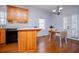 An eat-in kitchen features wood cabinets, hardwood floors, and white countertops at 2003 Hubbard Ct, Villa Rica, GA 30180