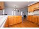 Bright eat-in kitchen with wood cabinets, hardwood floors, and view to living room at 2003 Hubbard Ct, Villa Rica, GA 30180