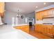 Bright eat-in kitchen with hardwood floors, wood cabinets, and view to the living room at 2003 Hubbard Ct, Villa Rica, GA 30180