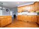 Spacious kitchen featuring wooden cabinetry and hardwood flooring that leads to an open fireplace at 2003 Hubbard Ct, Villa Rica, GA 30180