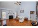 Inviting living room with hardwood floors, fireplace, and natural light from large windows at 2003 Hubbard Ct, Villa Rica, GA 30180