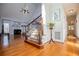 Open concept living room with fireplace, staircase, hardwood floors, and lots of natural light at 2003 Hubbard Ct, Villa Rica, GA 30180