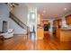 Open-concept floor plan with living room, staircase, and kitchen with wood cabinetry at 2003 Hubbard Ct, Villa Rica, GA 30180